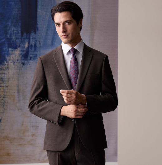 Man in smart brown suit and purple tie